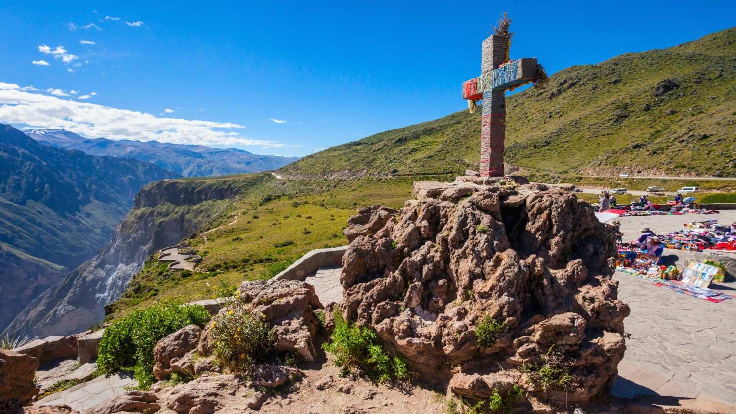 Cruz del Condor monument in Colca Canyon, Peru, set on a rocky outcrop with panoramic views of the canyon and surrounding Andes – a popular viewpoint for condor watching and cultural tourism.