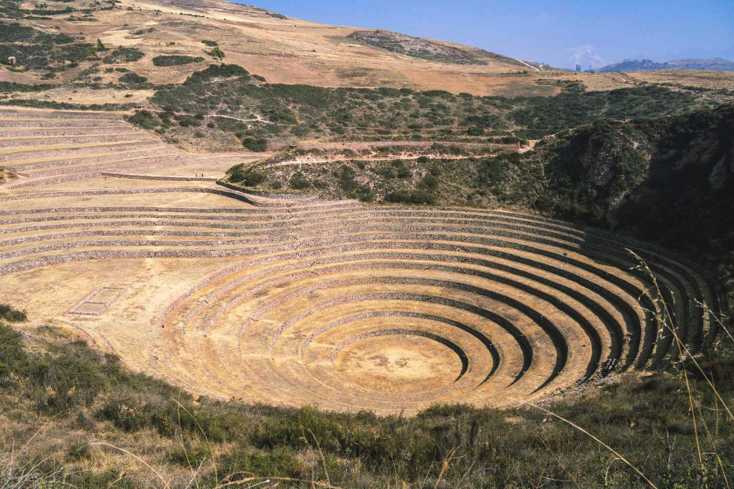 Panoramic view of the Moray Archaeological Site in the Sacred Valley of the Incas, featuring circular terraces once used by the Incas for agricultural experimentation – cultural tourism and trekking in the Peruvian Andes.